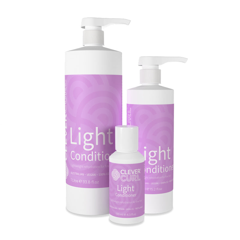 Three bottles of 'Clever Curl Light Conditioner' on a white background