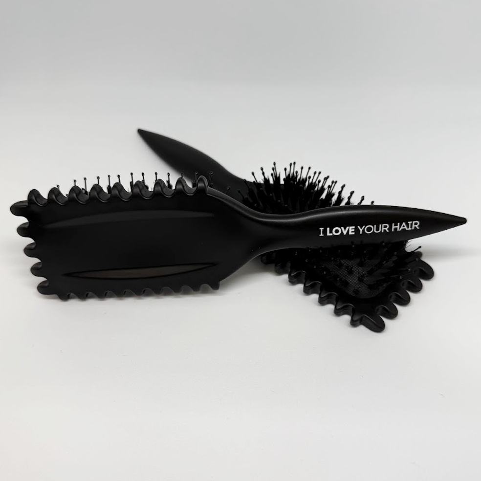 Black hairbrush with bristle design on a white background