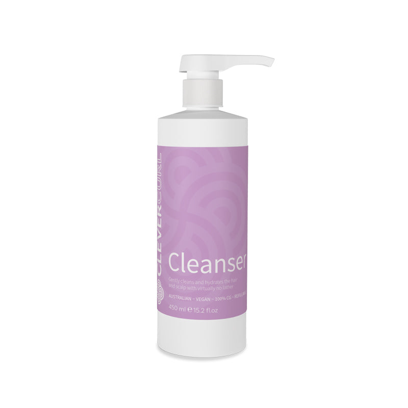 Bottle of cleanser with a purple label on a white background