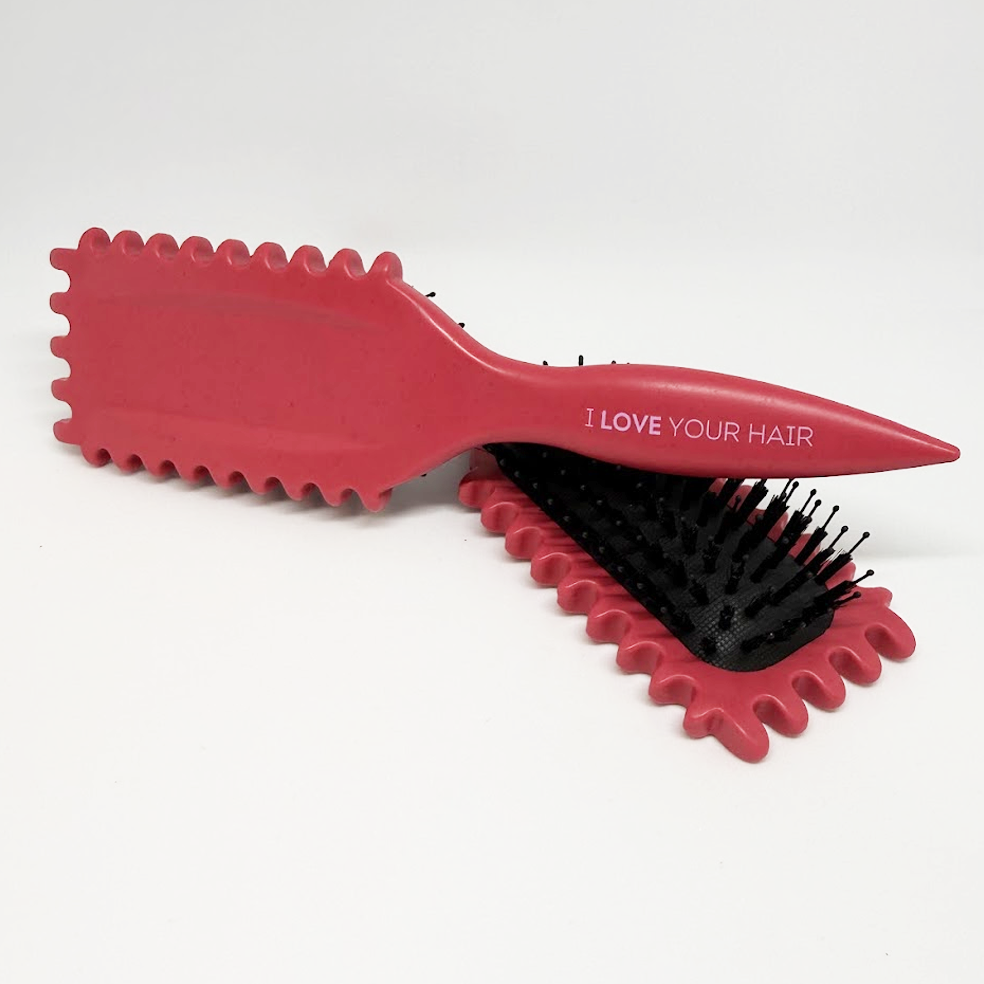 Red hairbrush with black bristles and 'I LOVE YOUR HAIR' text on a white background