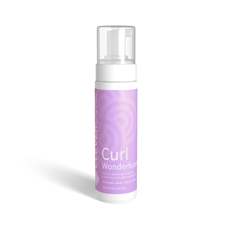 Purple bottle of Curl Wonderfoam on a white background